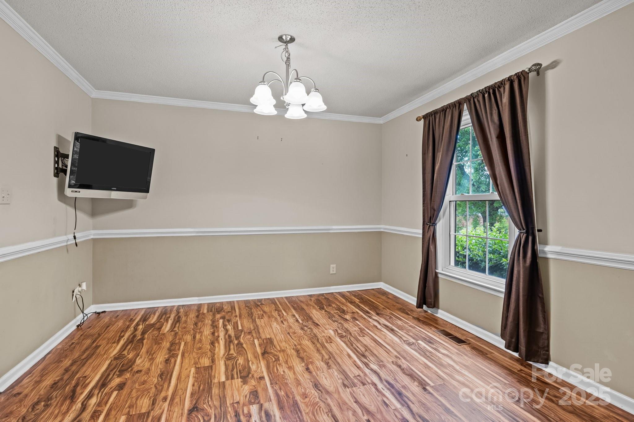 101 Wynnchester Road Gastonia, NC 28056 - Photo 7 of 46 a view of empty room with wooden floor and fan