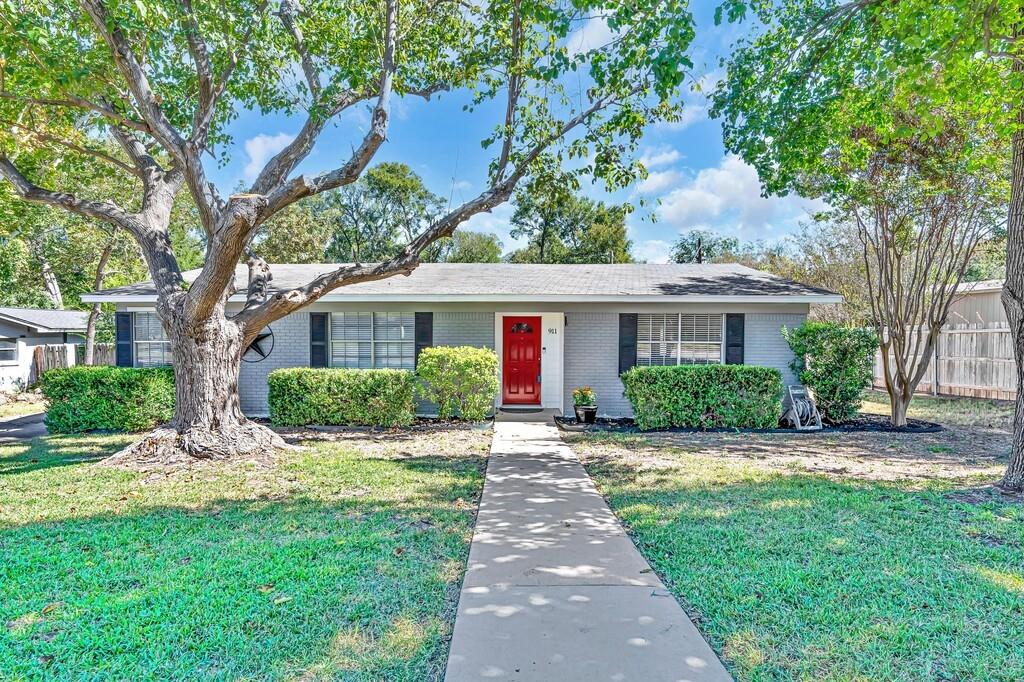 a front view of house with yard and green space