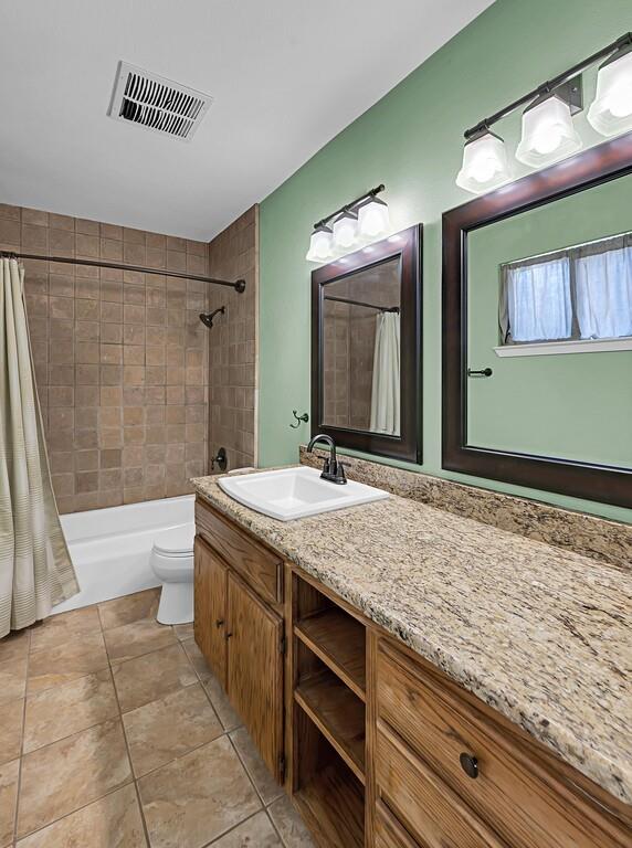 911 Fairway Road Woodway, TX 76712 - Photo 19 of 31 a bathroom with a granite countertop sink and a mirror