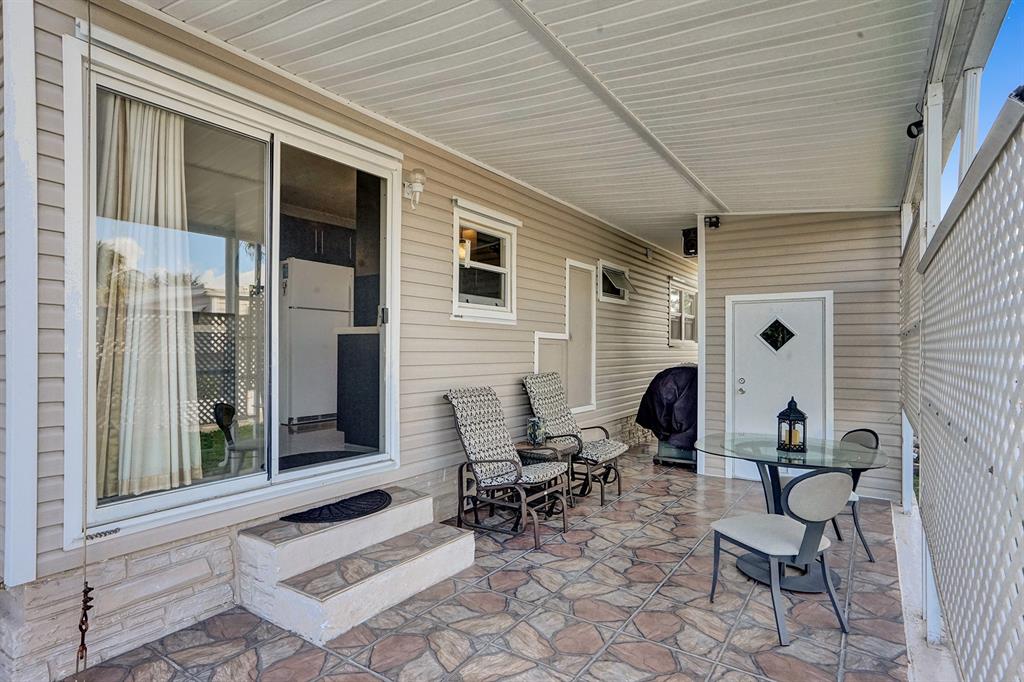 2301 Southwest 86th Terrace Davie, FL 33324 - Photo 16 of 31 a view of a patio with couple of chairs and a large window