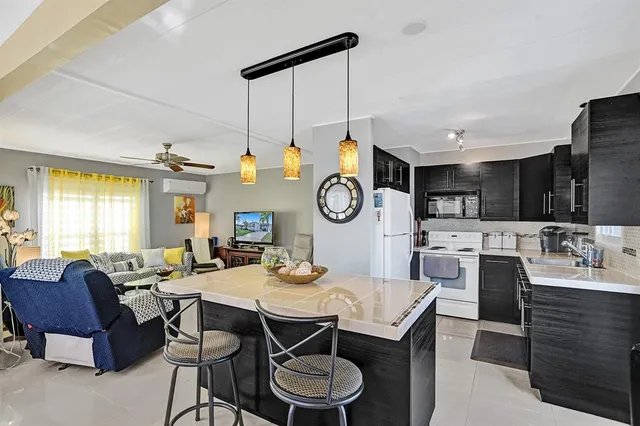 a view of a dining room with furniture a chandelier and wooden floor