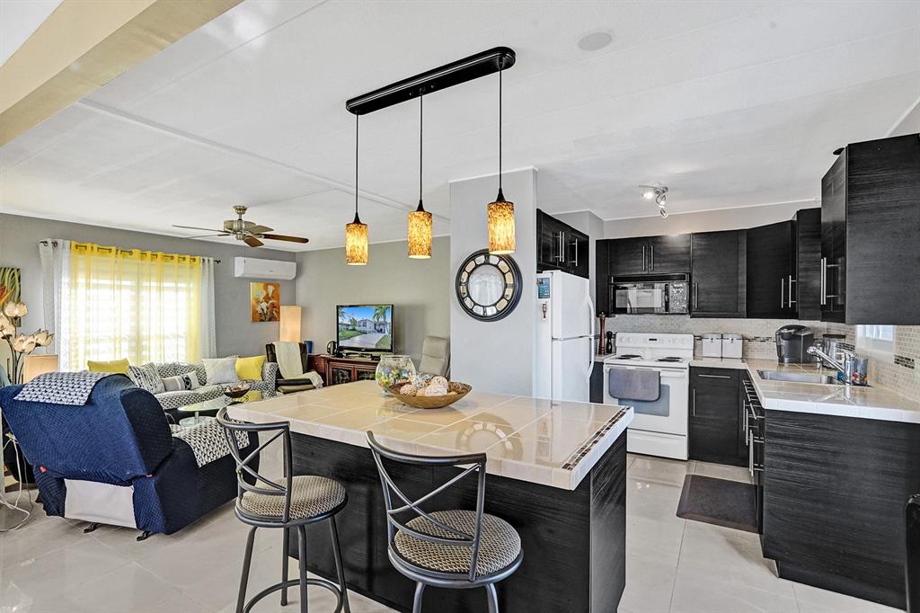 2301 Southwest 86th Terrace Davie, FL 33324 - Photo 19 of 31 a view of a dining room with furniture a chandelier and wooden floor