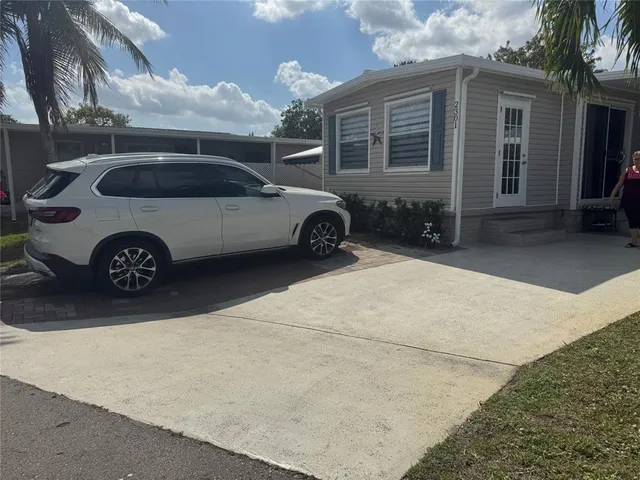 a view of a car parked front of a house