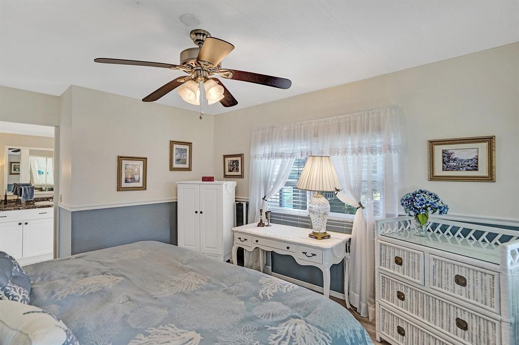 2301 Southwest 86th Terrace Davie, FL 33324 - Photo 24 of 31 a bedroom with a bed and a chandelier
