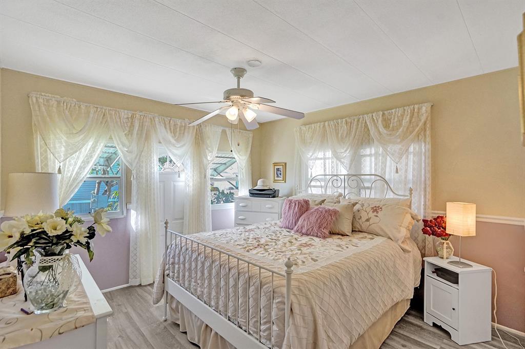 2301 Southwest 86th Terrace Davie, FL 33324 - Photo 10 of 31 a bedroom with a bed and wooden floor