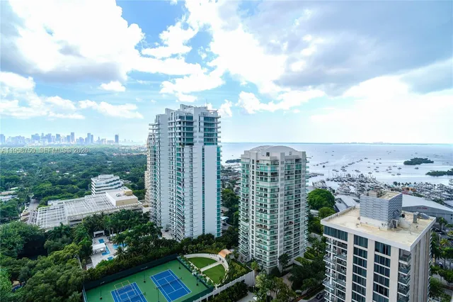 a view of a patio with chairs and floor to ceiling window