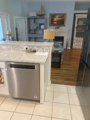 a kitchen with kitchen island granite countertop a stove and a sink