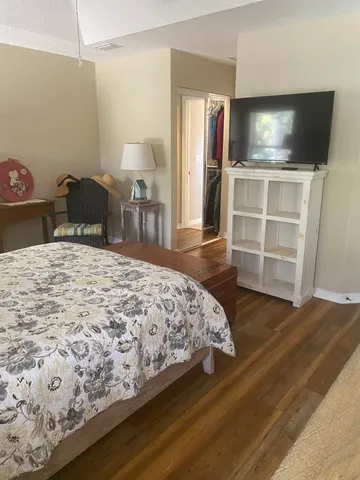 a bedroom with a bed and a television