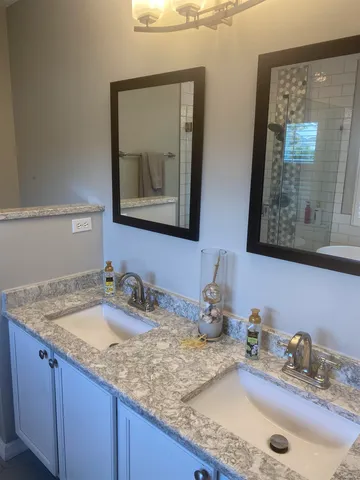a bathroom with sinks and mirror