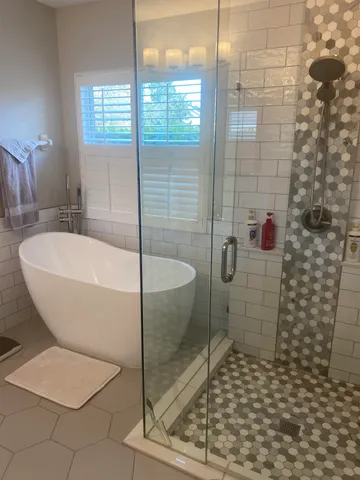 a bathroom with a bathtub and shower