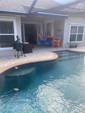 a view of a house with backyard porch and sitting area