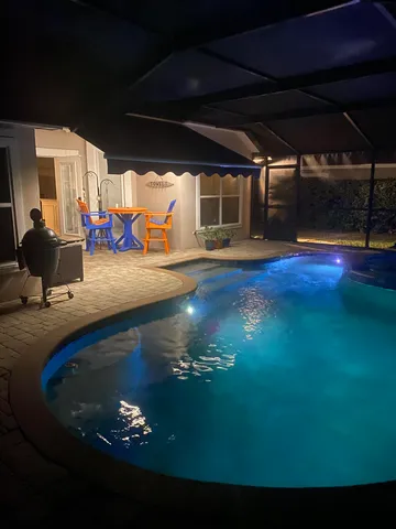 a view of swimming pool with seating space