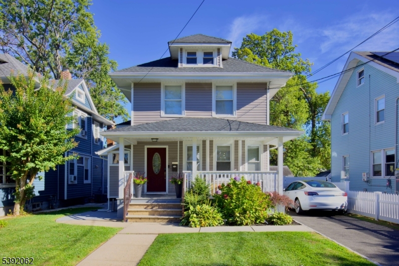 a front view of a house with yard and green space