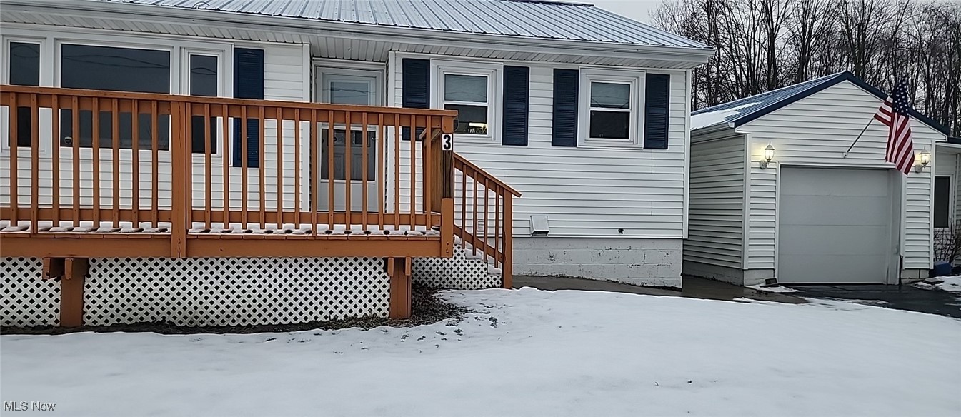 3113 Hague Road Orwell, OH 44076 - Photo 1 of 23 Snow covered deck featuring a garage