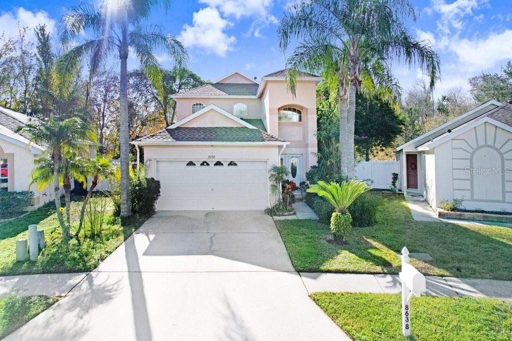 8638 Hawbuck Street Trinity, FL 34655 - Photo 1 of 43 a front view of a house with garden