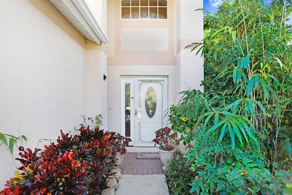 8638 Hawbuck Street Trinity, FL 34655 - Photo 11 of 43 view of a house with a flower garden