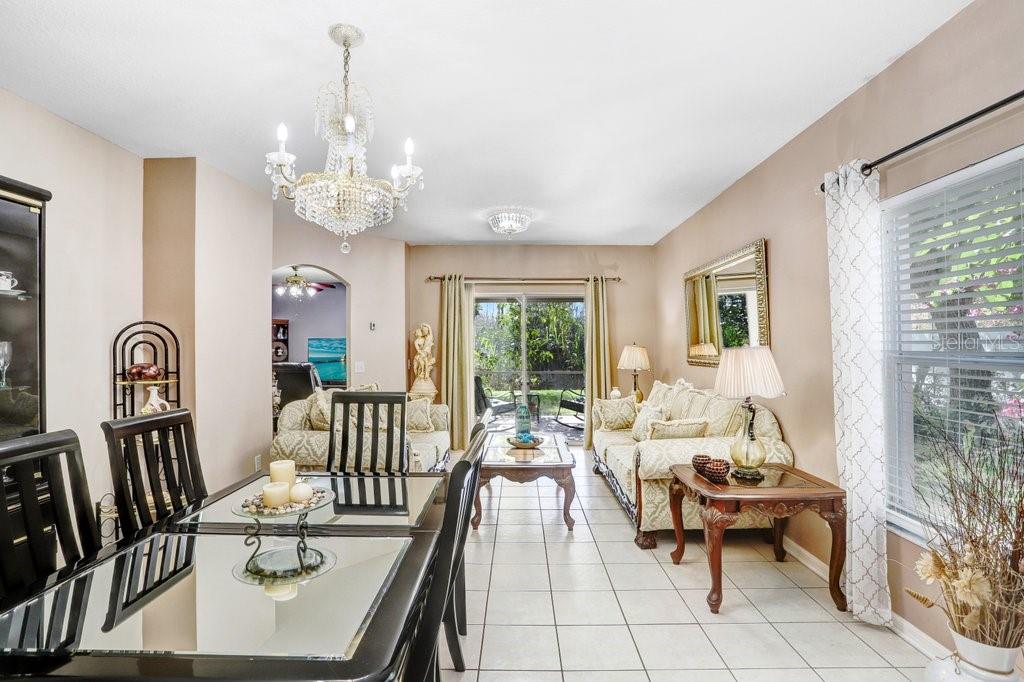 8638 Hawbuck Street Trinity, FL 34655 - Photo 16 of 43 a living room with furniture and a chandelier