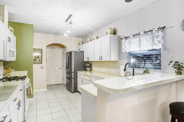 a kitchen with cabinets and appliances