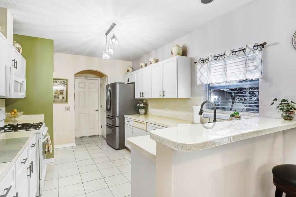 8638 Hawbuck Street Trinity, FL 34655 - Photo 17 of 43 a kitchen with a sink appliances and cabinets