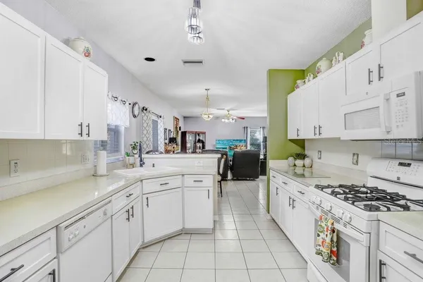 a dining room filled with furniture and a chandelier