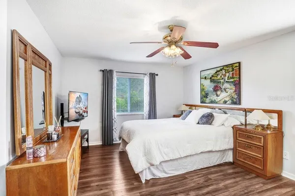 a bedroom with a bed and wooden floor