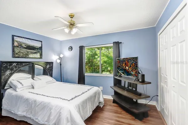 a bedroom with a bed and a chandelier