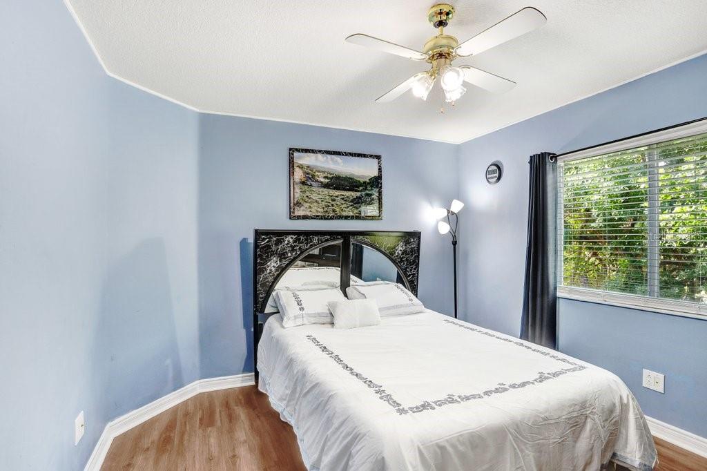 8638 Hawbuck Street Trinity, FL 34655 - Photo 30 of 43 a bedroom with a bed and a chandelier