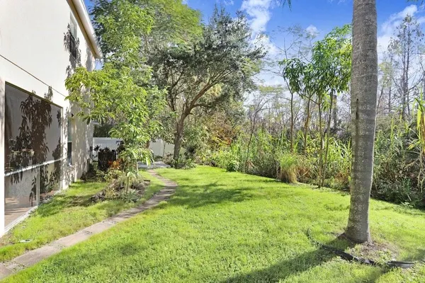 a view of a chair and table in backyard of the house