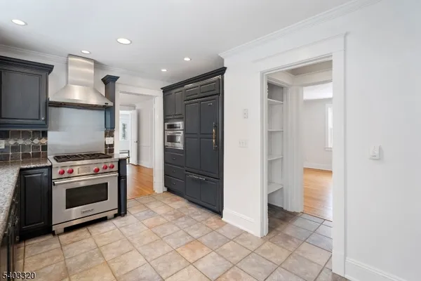 a kitchen with stainless steel appliances granite countertop a refrigerator and a stove