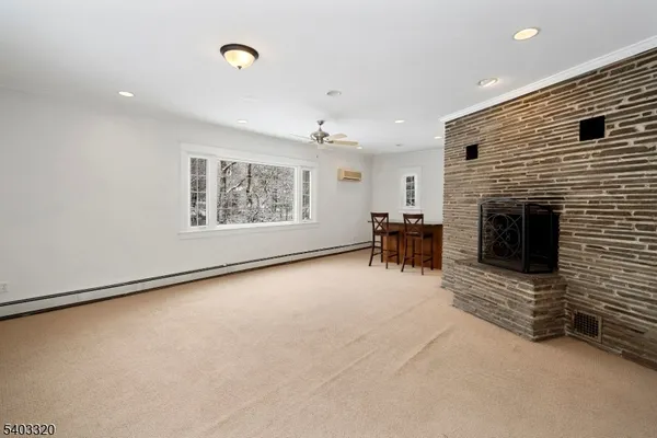 a view of an empty room with a fireplace and a window