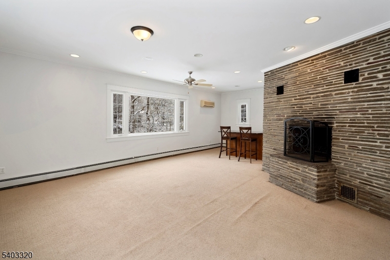 170 New Providence Road Mountainside, NJ 07092 - Photo 18 of 50 a view of an empty room with a fireplace and a window