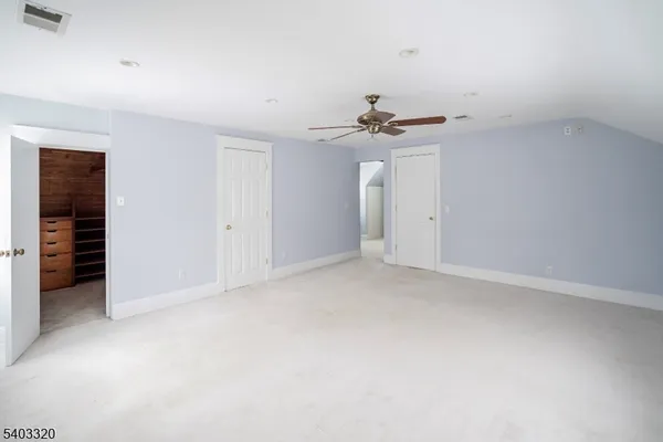 a view of an empty room with a ceiling fan