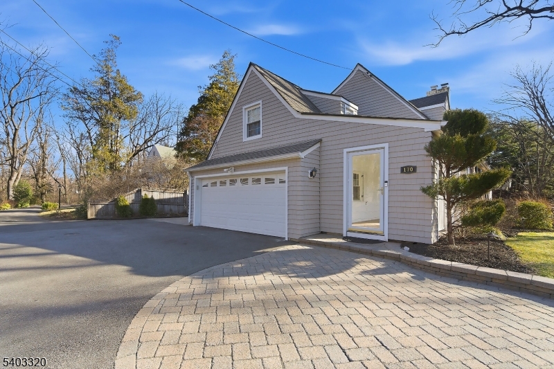 170 New Providence Road Mountainside, NJ 07092 - Photo 3 of 50 a front view of a house with a yard and garage
