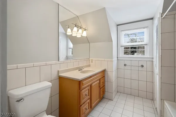 a bathroom with a sink a toilet and mirror