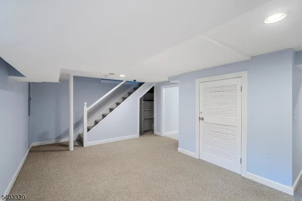 a view of an empty room with stairs