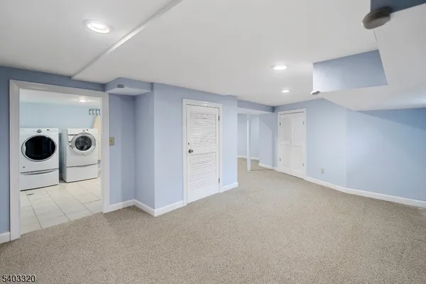 an empty room with glass door and shower