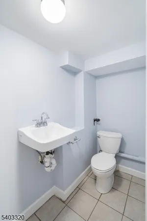 a bathroom with a sink toilet and a mirror