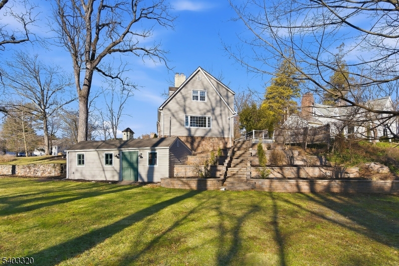 170 New Providence Road Mountainside, NJ 07092 - Photo 44 of 50 a front view of a house with a yard table and chairs