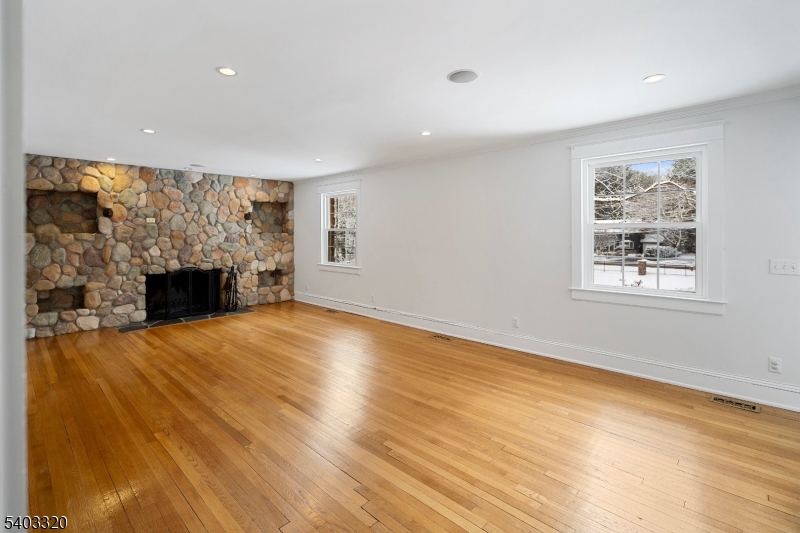 170 New Providence Road Mountainside, NJ 07092 - Photo 7 of 50 a view of empty room with wooden floor and fireplace