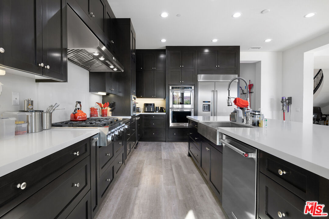 20234 Jubilee Way Porter Ranch, CA 91326 - Photo 8 of 30 a large kitchen with stainless steel appliances lots of counter space and a sink