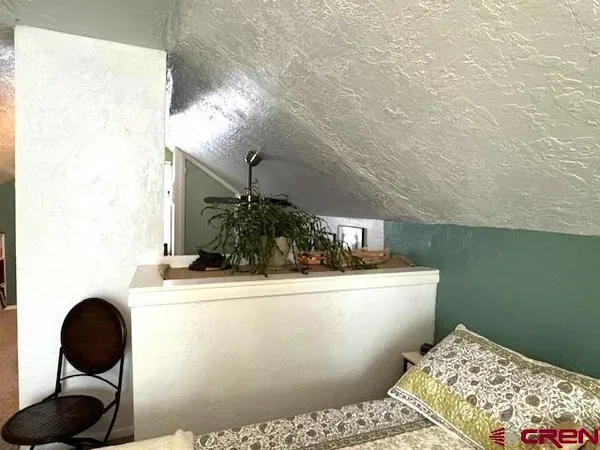 a view of a house with a yard covered in snow