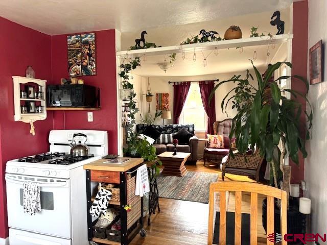 308 North Beech Street Cortez, CO 81321 - Photo 19 of 35 a front view of a dining room with furniture and floor to ceiling window