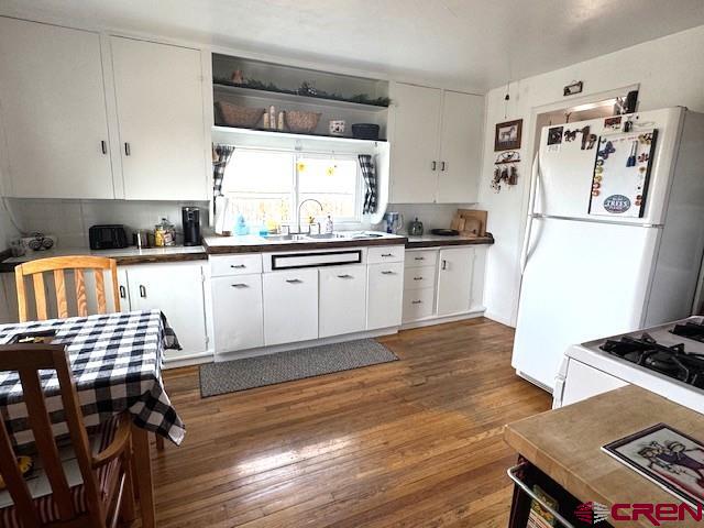 308 North Beech Street Cortez, CO 81321 - Photo 24 of 35 a kitchen with granite countertop a stove a sink dishwasher and a refrigerator