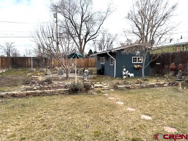308 North Beech Street Cortez, CO 81321 - Photo 34 of 35 a view of a house with a yard covered in snow