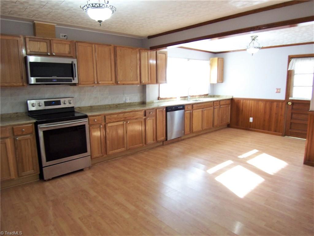 858 Cable Creek Road Asheboro, NC 27205 - Photo 8 of 26 Kitchen and dining room. All new cabinets, appliances and granite countertops
