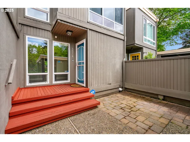 a backyard of a house with seating space and trees