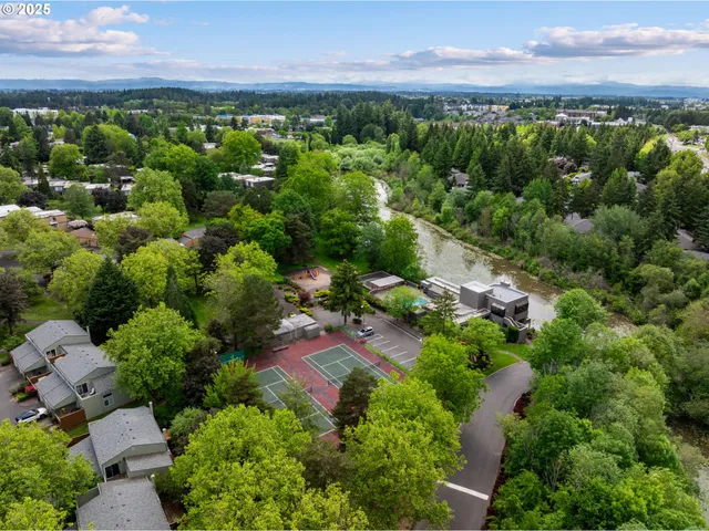 an aerial view of a houses with a yard