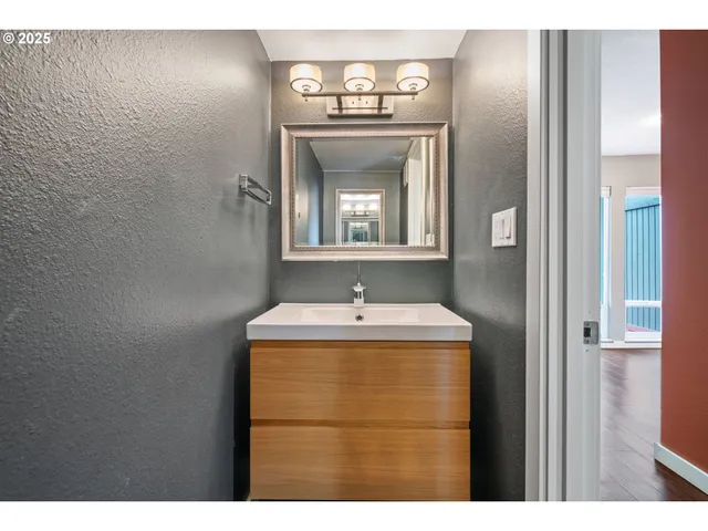 a view of a bathroom with a sink and a mirror