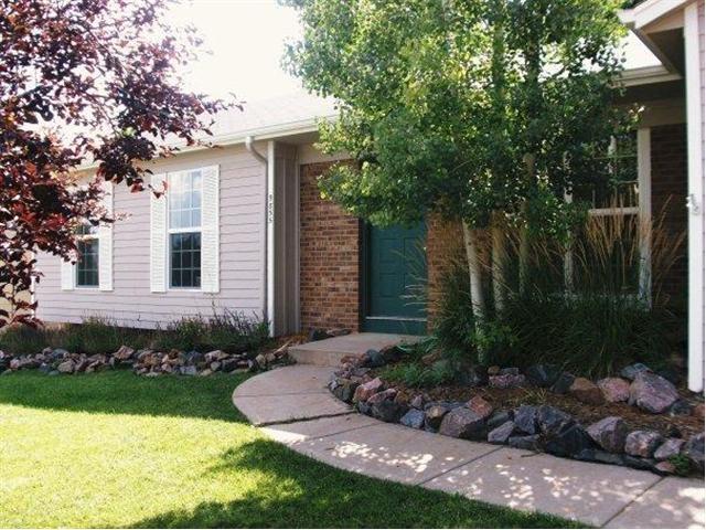 9855 Decatur Street Federal Heights, CO 80260 - Photo 1 of 1 a front view of a house with garden