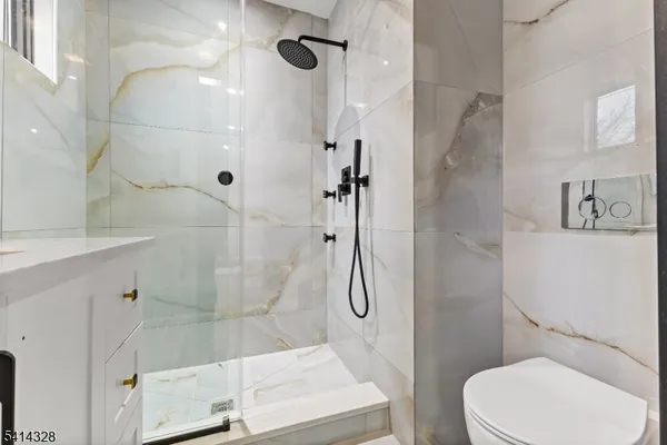 a white toilet sitting next to a bathroom sink
